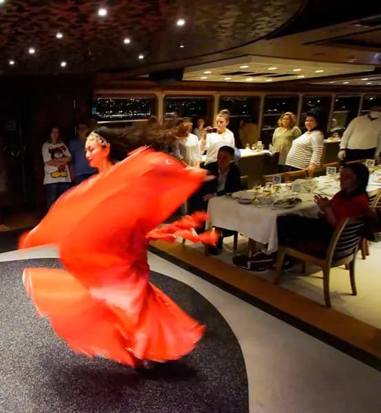 A dancer in a flowing red dress caught mid-turn on the dance floor