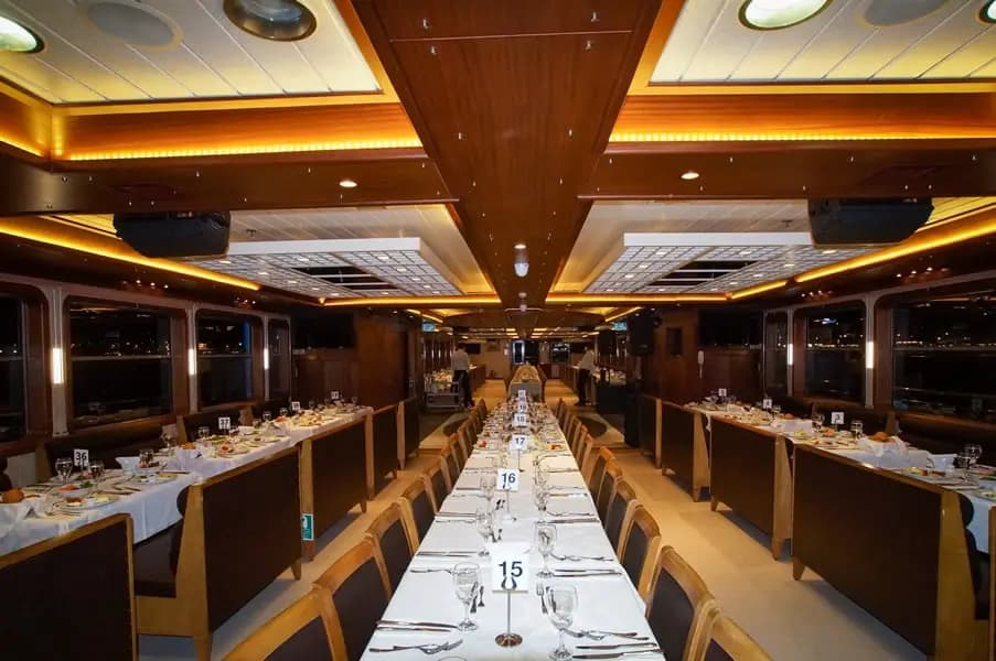 A wide view down the full length of the BOSFOR's dining saloon, tables numbered and set for service