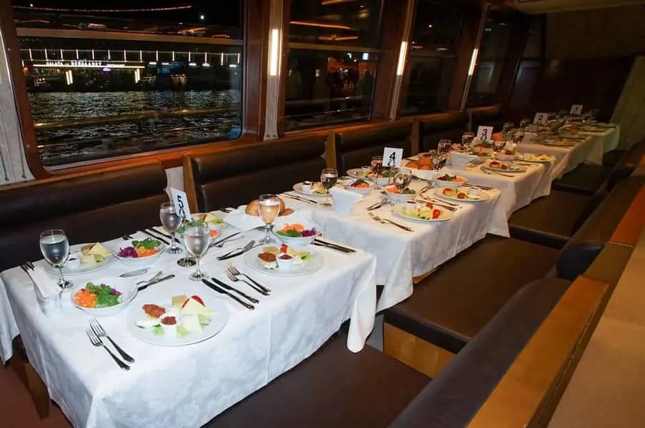 A table set aboard the BOSFOR with a numbered card and a full meze spread