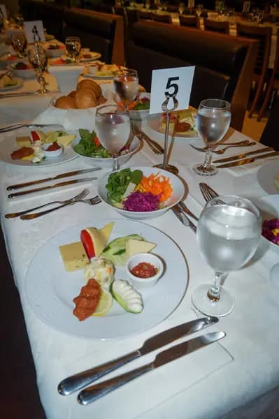 A close view of a table set aboard the BOSFOR, shown in portrait orientation